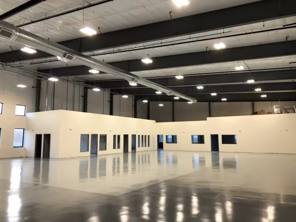 Commercial warehouse with high-bay LED lighting after electrical fit-out for new construction in NH.