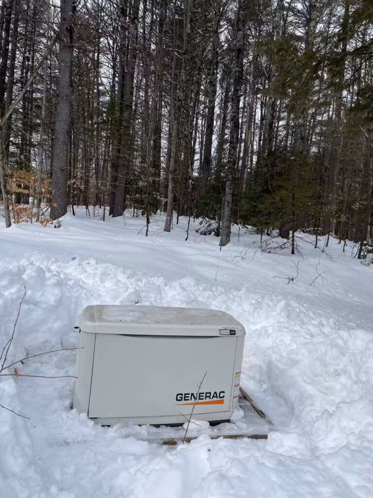 Backup Generac generator cleared of snow during a New Hampshire winter.