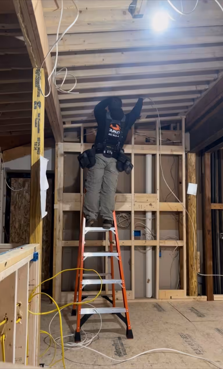an electrician installing wiring during a home remodeling project