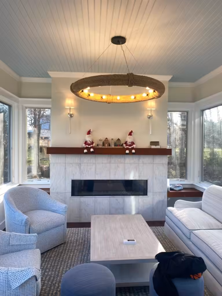 Cozy sunroom featuring rope-wrapped circular chandelier lighting installed by licensed electricians in Rye, New Hampshire.