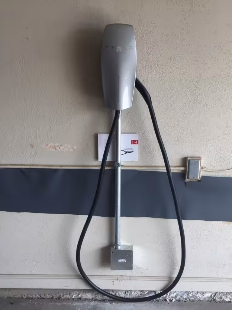 Level 2 Tesla Wall Connector professionally installed on a garage wall in Portsmouth, New Hampshire.