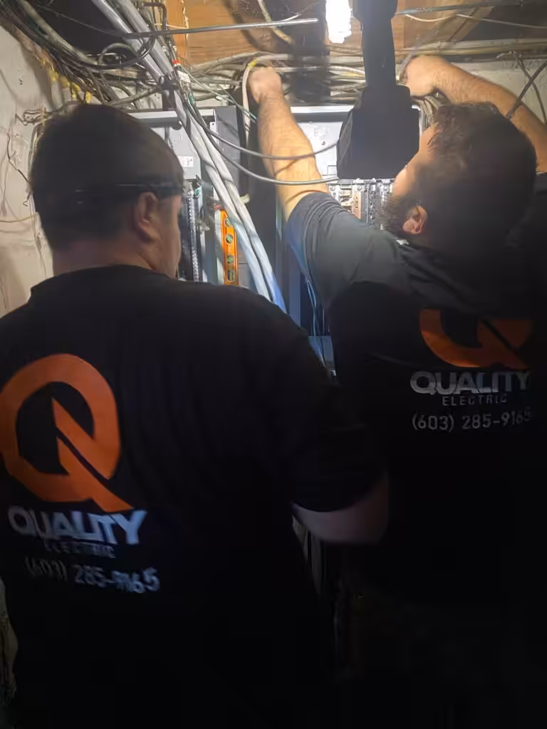 Local electrician from Loyal Lab Electric & Generators training an apprentice at a residential job site in Dover, NH.