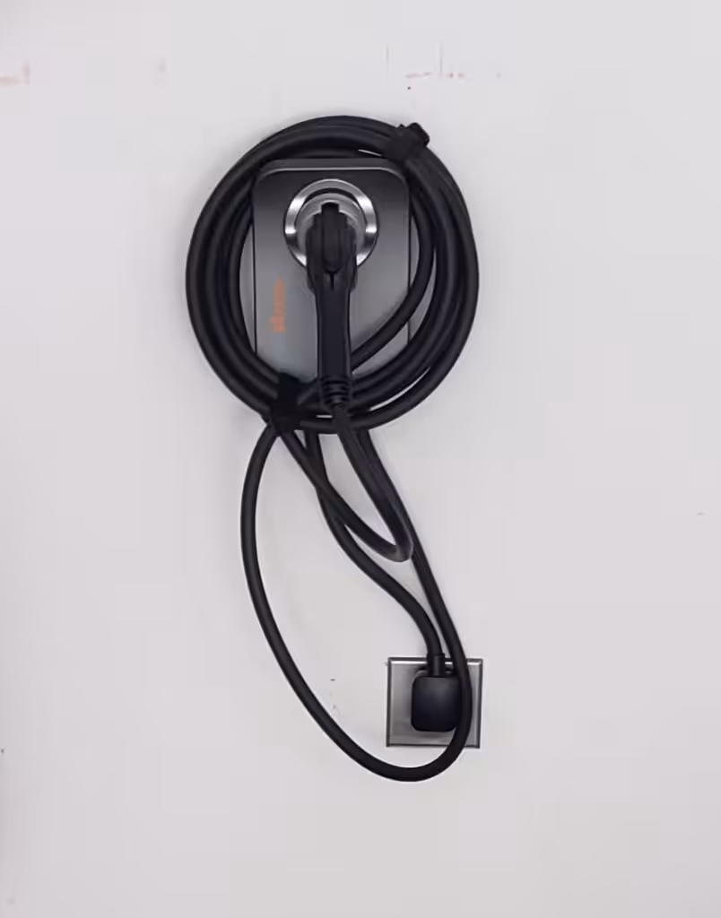 Plug-in Level 2 EV charger installed on a garage wall in NH.