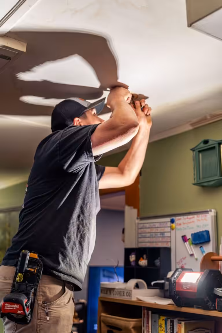 Licensed electrician troubleshooting light fixture wiring in a Dover, NH home