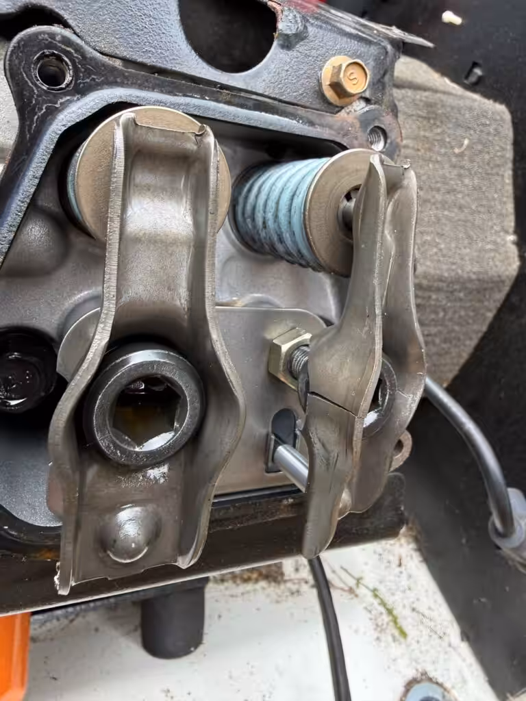 Broken valve rocker arm removed from a Generac standby generator during a repair by Loyal Lab Electric
