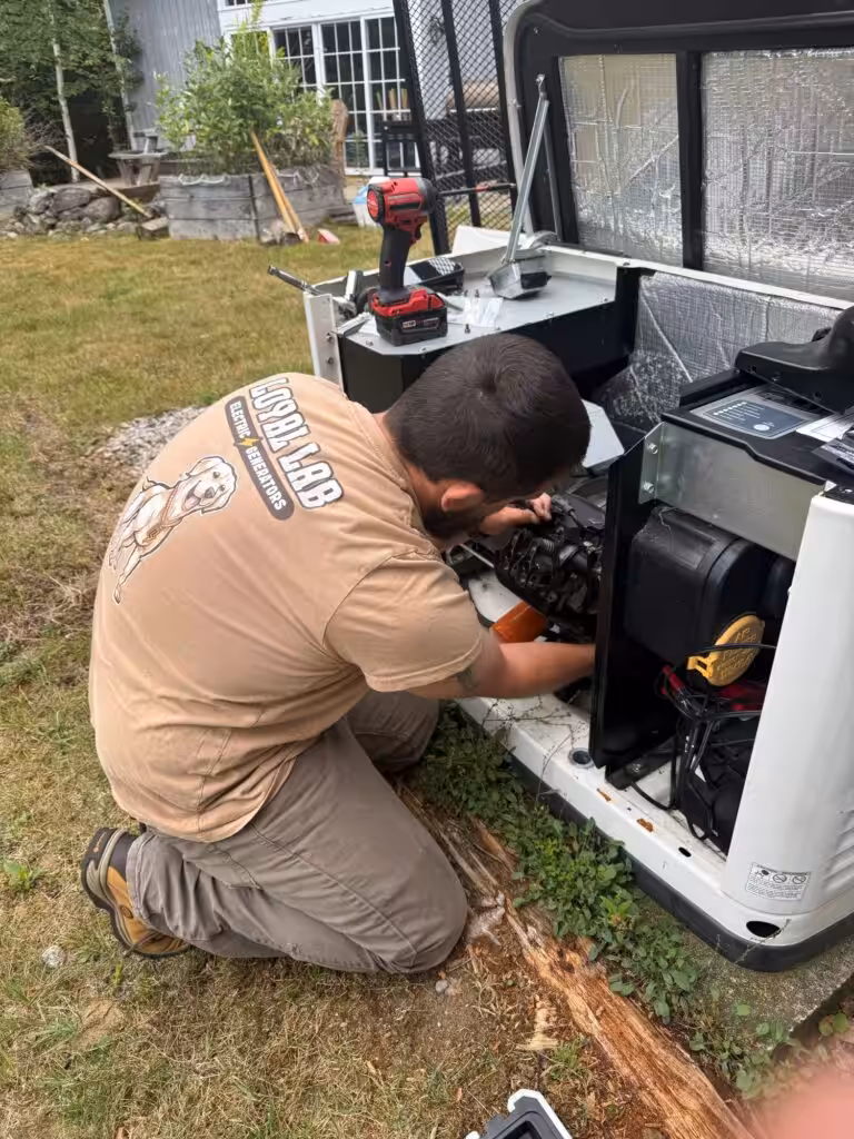 Loyal Lab owner Eric performing maintenance on a Generac standby generator in Wolfeboro NH
